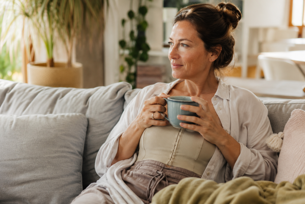 Woman recovering comfortably at home after mommy makeover surgery in Portland Oregon