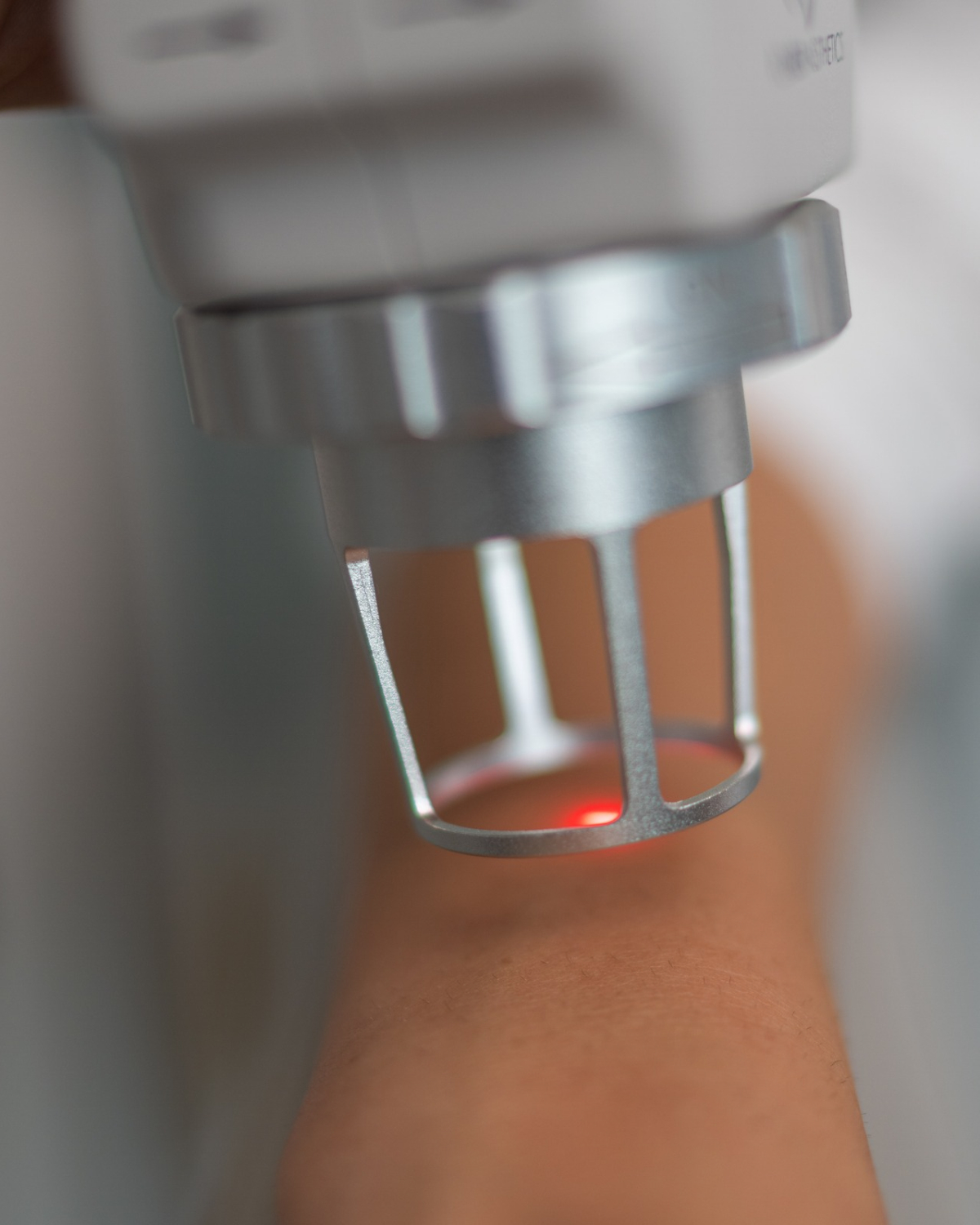 Dr. Tina Jenq holding a fractional CO2 laser handpiece during a skin treatment at her Happy Valley clinic